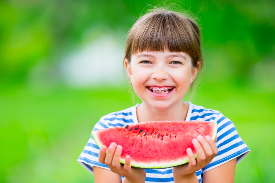 Girl braces eating a watermelon slice170