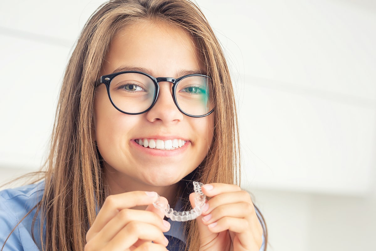 Young girl with dental invisible braces.